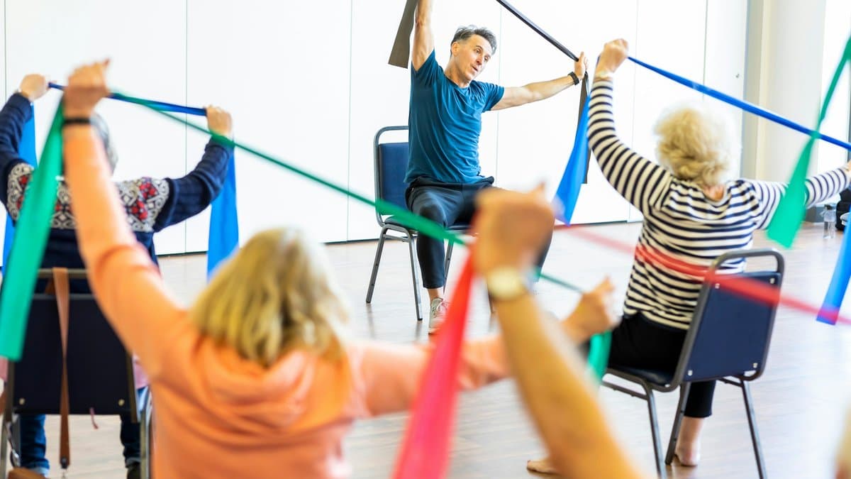 A therapist working with a client on rehabilitation exercises at home