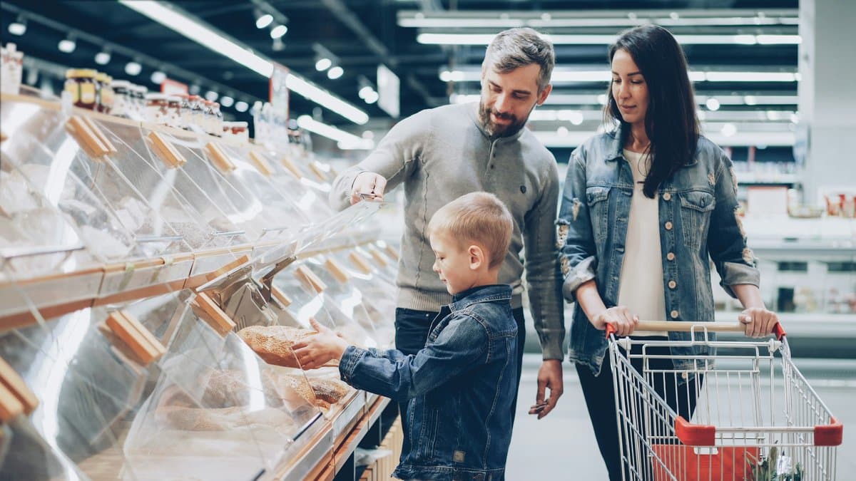 A caregiver helping organize groceries in a home kitchen